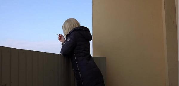  A blonde without panties smokes on a public balcony and masturbates with a dildo. Fetish and juicy PAWG under a short dress outdoor.